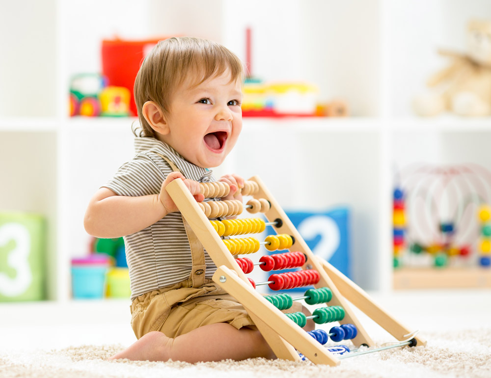 A cheerful child playing with an abacus, expressing joy