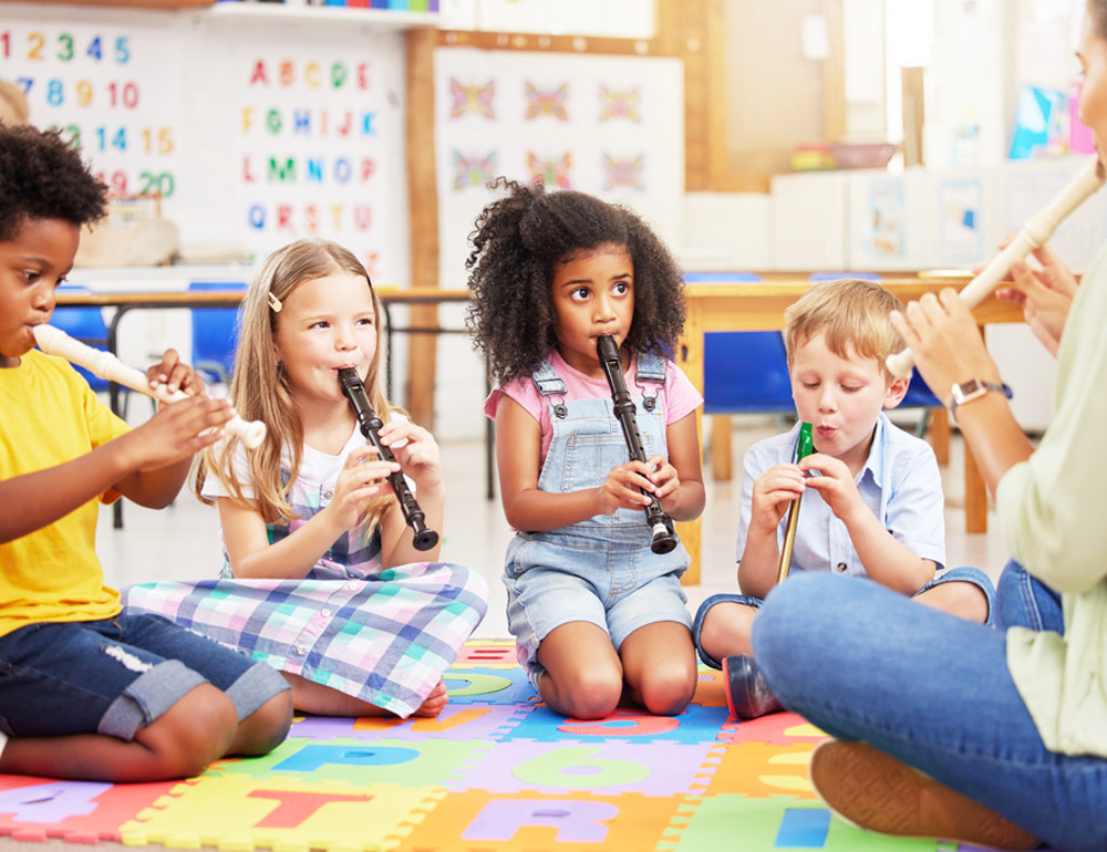 Children playing musical instruments together, enjoying a fun and collaborative music session.