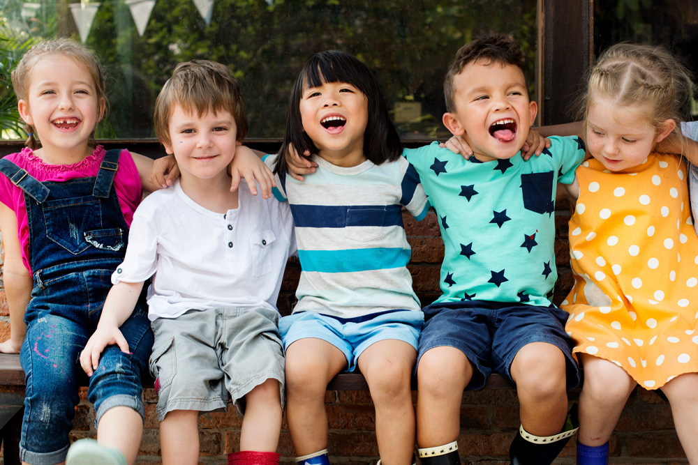 A joyful group of children sitting together, showcasing friendship and happiness