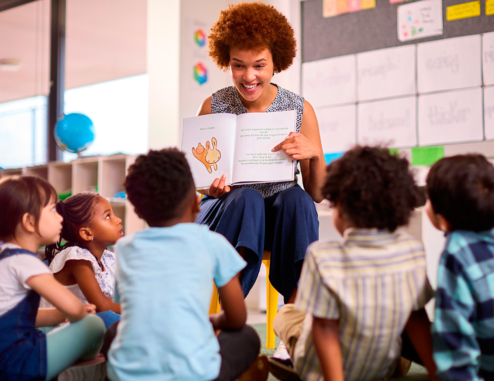 An engaging teacher reading a book to a group of attentive children, fostering a love for stories