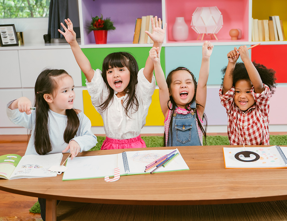 A group of happy children, joyfully raising their hands while engaging in creative activities, celebrating learning and fun.