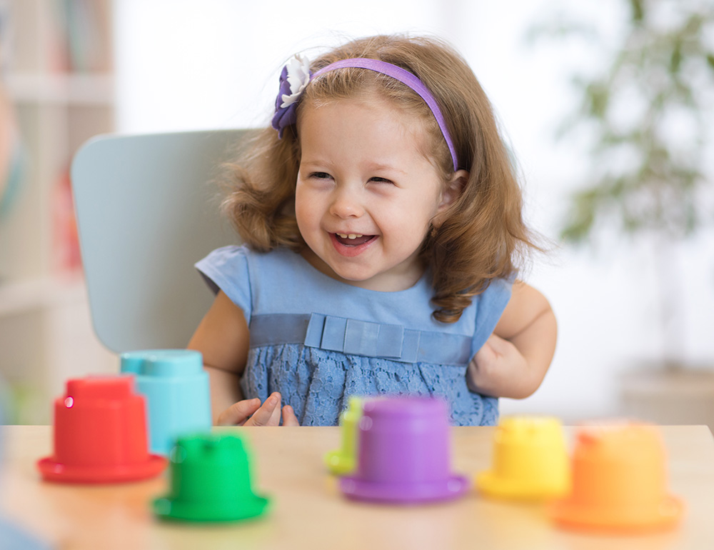 A cheerful girl with a big smile, enjoying playtime