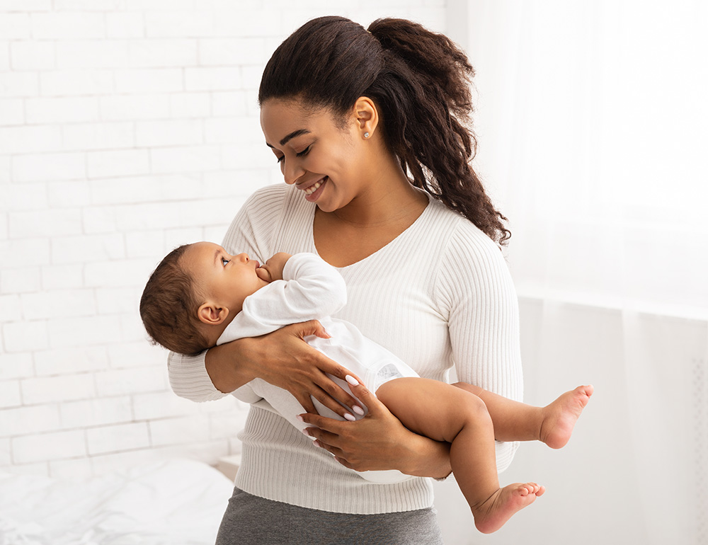 A loving moment between a teacher and baby, showcasing warmth and connection as they share a joyful interaction.